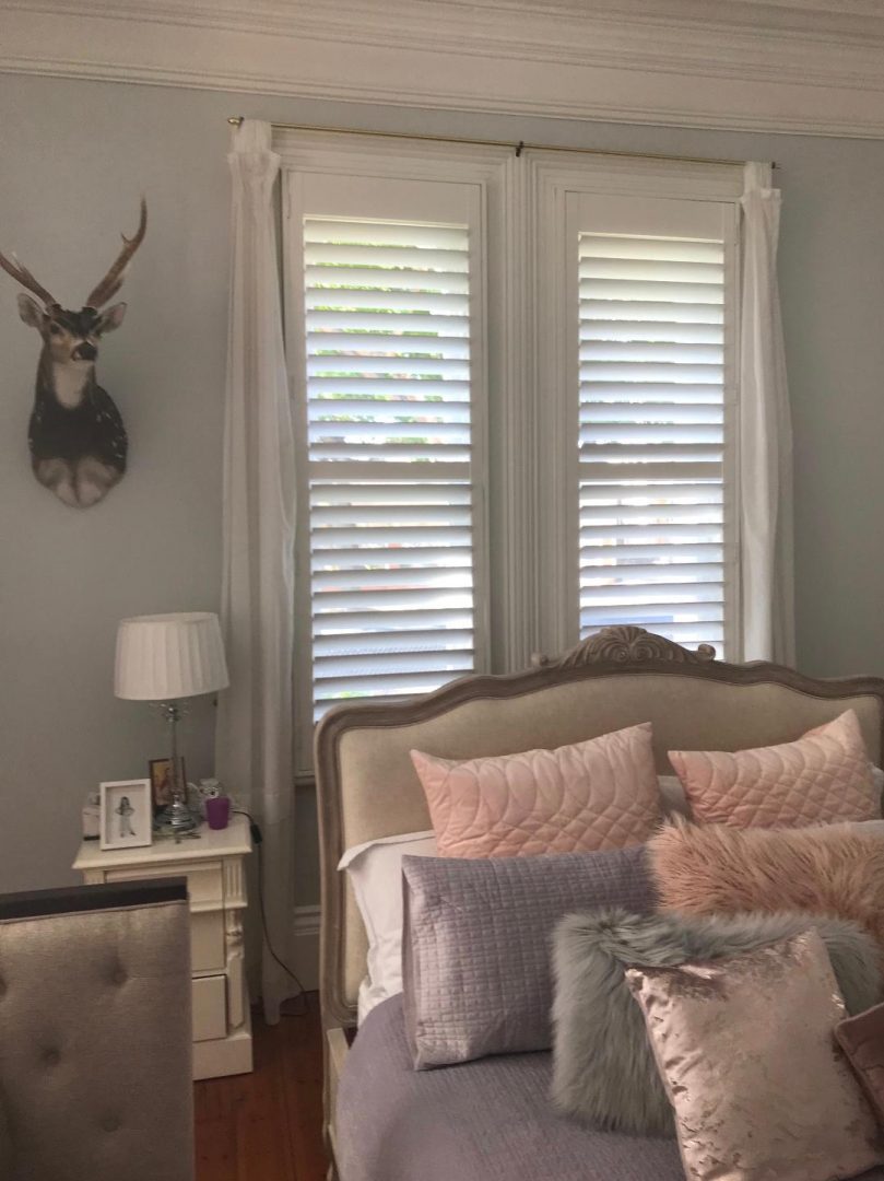 White plantation shutters in a contemporary home interior.